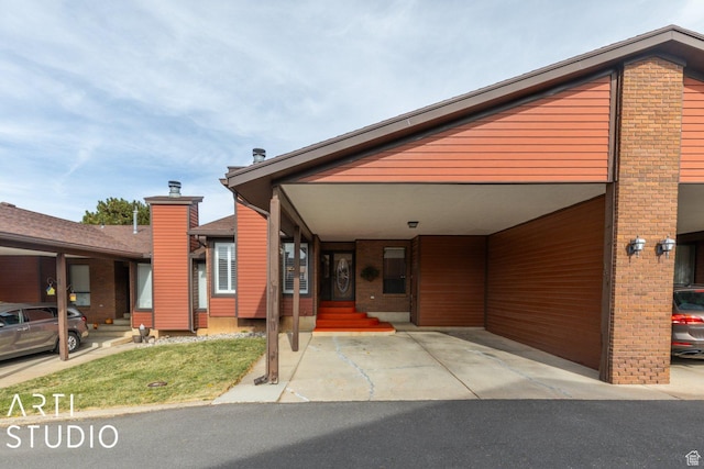 1314 E 1990 S, Ogden, UT 84401 - view of front facade with entry steps, a carport, and brick siding
