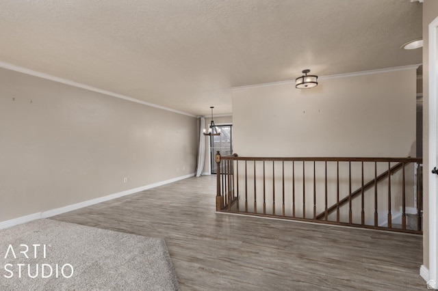 1314 E 1990 S, Ogden, UT 84401 - spare room with wood finished floors, a textured ceiling, baseboards, crown molding, and a notable chandelier