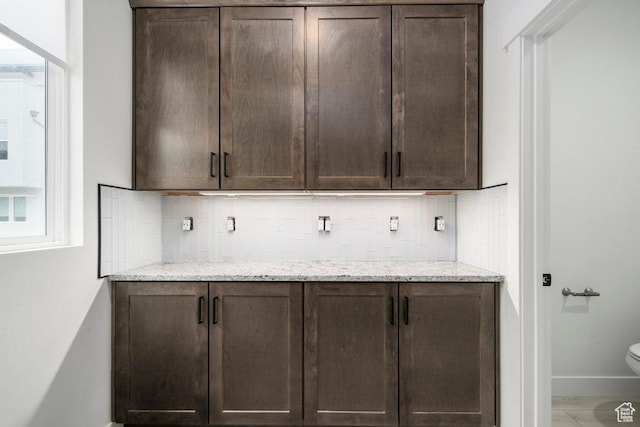 11056 S Lake Run Rd, South Jordan, UT 84009 - bar with baseboards and decorative backsplash