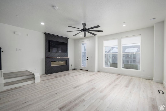 11056 S Lake Run Rd, South Jordan, UT 84009 - unfurnished living room featuring a fireplace, ceiling fan, recessed lighting, and wood finished floors