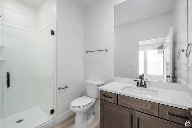11056 S Lake Run Rd, South Jordan, UT 84009 - full bathroom featuring toilet, wood finished floors, a stall shower, baseboards, and vanity