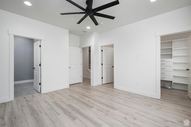 11056 S Lake Run Rd, South Jordan, UT 84009 - unfurnished bedroom featuring baseboards, wood finished floors, a walk in closet, and recessed lighting