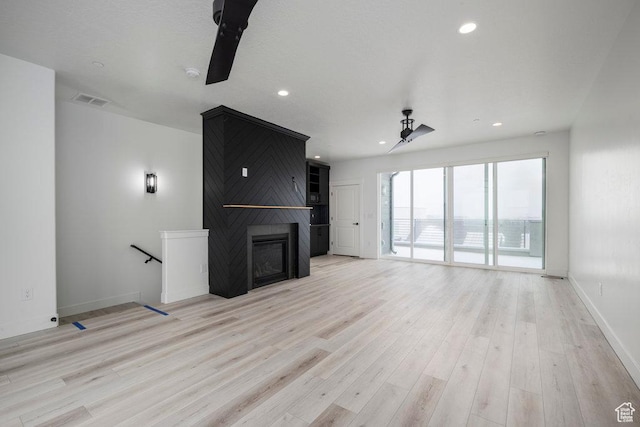 11056 S Lake Run Rd, South Jordan, UT 84009 - unfurnished living room featuring recessed lighting, baseboards, visible vents, a fireplace, and light wood-type flooring