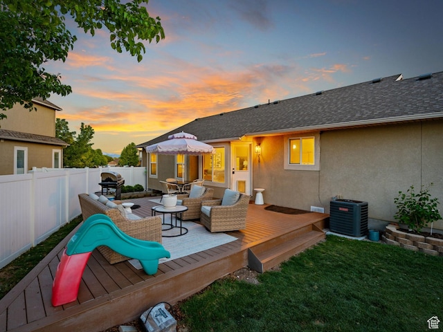 4529 W Gladstone Cir, Riverton, UT 84096 - deck at dusk featuring central AC, a yard, an outdoor hangout area, and a fenced backyard