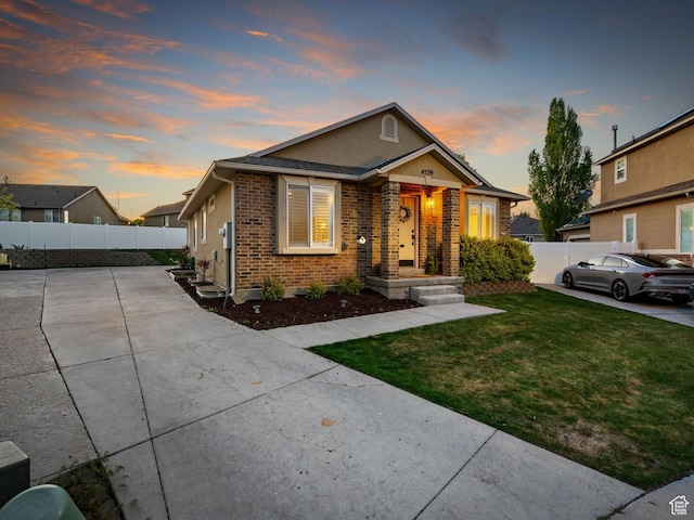 4529 W Gladstone Cir, Riverton, UT 84096 - bungalow-style home featuring a yard, fence, and brick siding