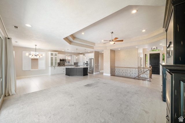 2996 S Limestone Dr, St George, UT 84790 - unfurnished living room featuring recessed lighting, baseboards, visible vents, ceiling fan with notable chandelier, and light colored carpet