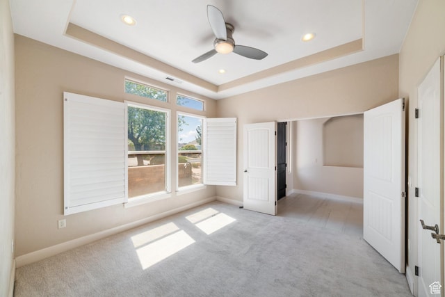 2996 S Limestone Dr, St George, UT 84790 - unfurnished bedroom with light colored carpet, visible vents, recessed lighting, a raised ceiling, and baseboards