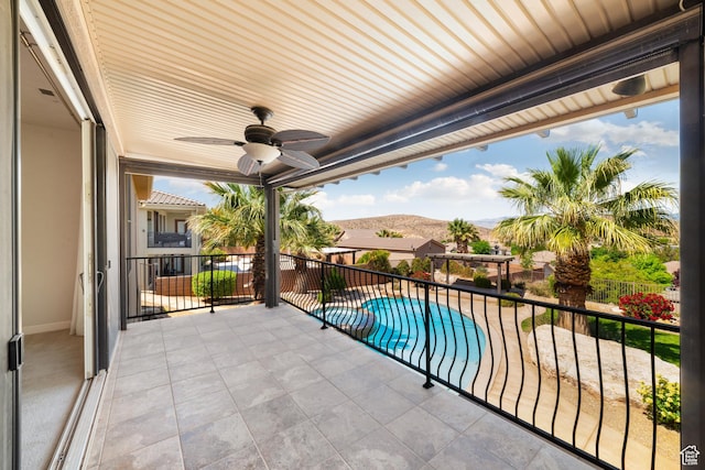 2996 S Limestone Dr, St George, UT 84790 - balcony with a ceiling fan, a mountain view, and a pool with connected hot tub