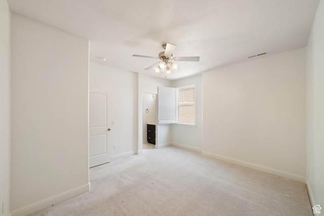 2996 S Limestone Dr, St George, UT 84790 - spare room featuring visible vents, baseboards, a ceiling fan, and light carpet