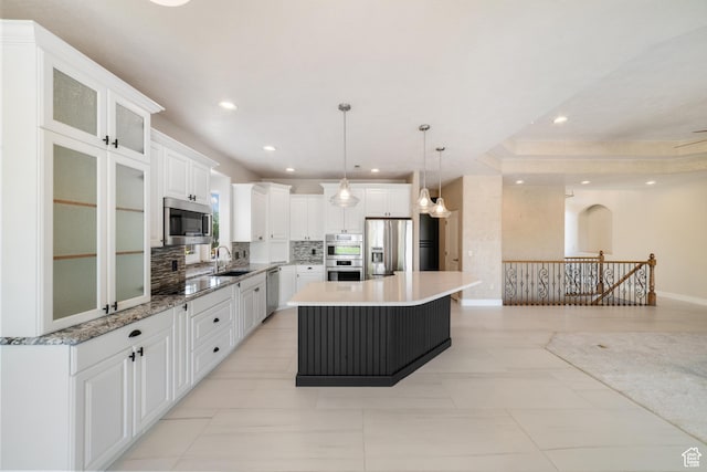 2996 S Limestone Dr, St George, UT 84790 - kitchen featuring a center island, stainless steel appliances, white cabinetry, backsplash, and recessed lighting