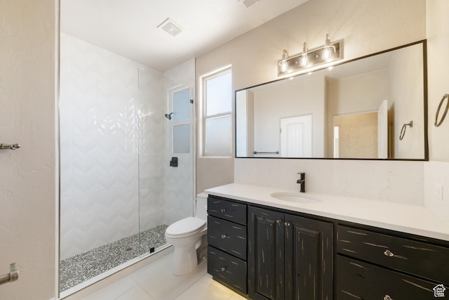 2996 S Limestone Dr, St George, UT 84790 - bathroom featuring toilet, tiled shower, tile patterned floors, visible vents, and vanity
