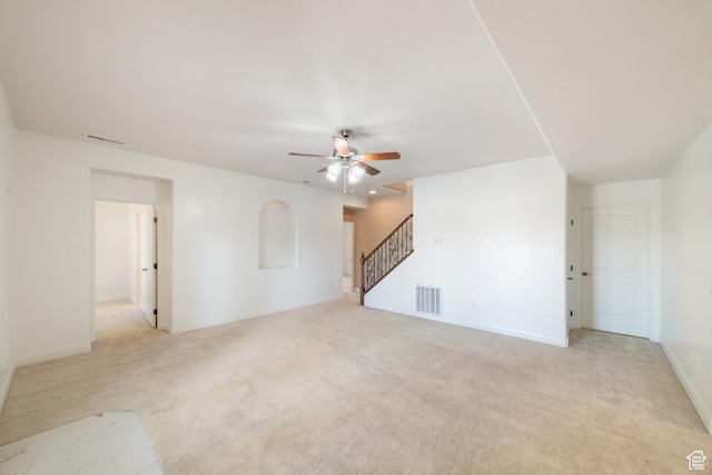 2996 S Limestone Dr, St George, UT 84790 - unfurnished living room with stairway, visible vents, ceiling fan, and light colored carpet