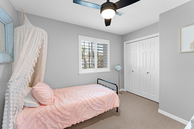 bedroom with carpet, a closet, baseboards, and ceiling fan