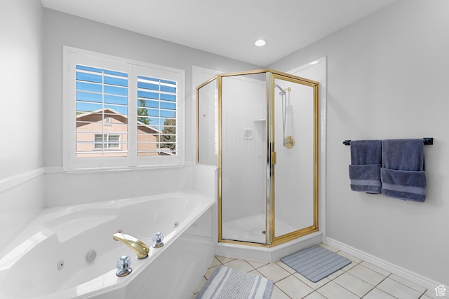 bathroom with a tub with jets, baseboards, a shower stall, and tile patterned floors