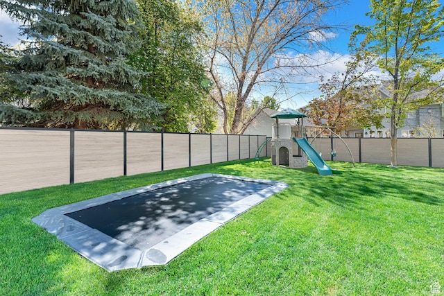 view of yard with a fenced backyard and a playground