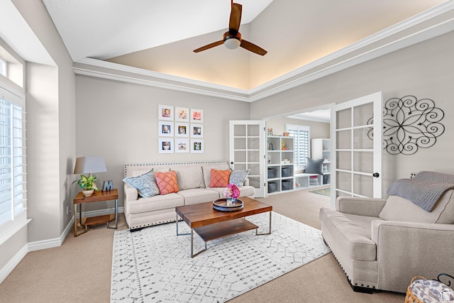 carpeted living area featuring a wealth of natural light, french doors, lofted ceiling, and ceiling fan