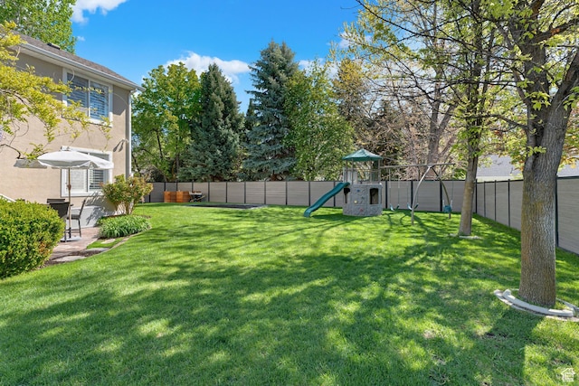 view of yard with a playground and a fenced backyard
