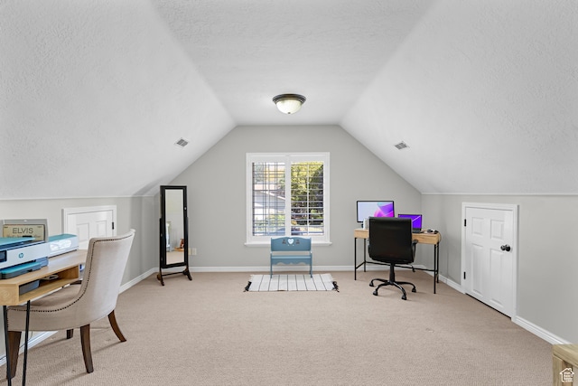 carpeted office space featuring baseboards, visible vents, a textured ceiling, and vaulted ceiling