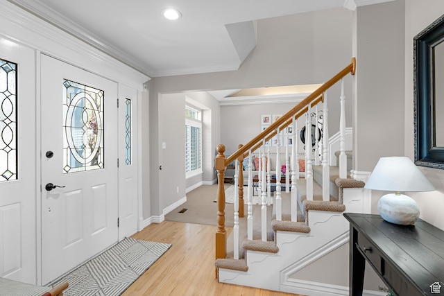 entrance foyer with crown molding, stairs, recessed lighting, and light wood-style floors