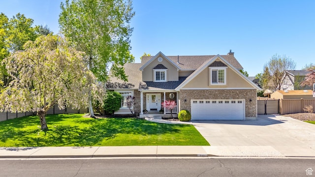 craftsman-style house with fence, an attached garage, concrete driveway, stucco siding, and a front yard
