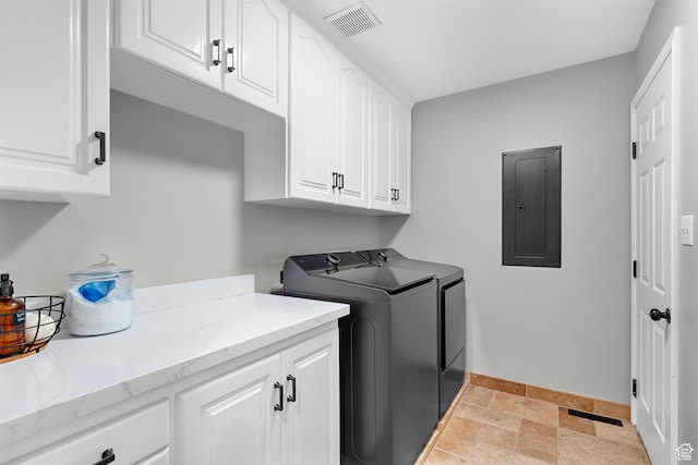 laundry area featuring washing machine and dryer, baseboards, visible vents, electric panel, and cabinet space
