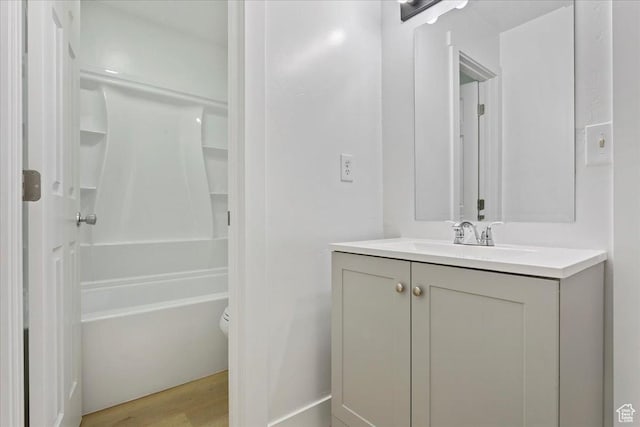 5630 S Meadow Ln E Unit 175, South Ogden, UT 84403 - bathroom featuring vanity, wood finished floors, bathing tub / shower combination, and toilet