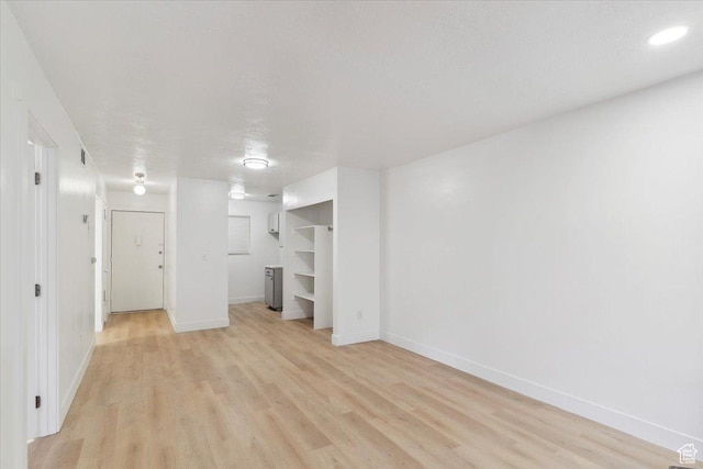 interior space with light wood-style flooring, baseboards, a closet, and visible vents