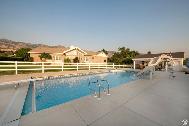 105 S 400 E, Hyde Park, UT 84318 - view of pool with a fenced in pool, a mountain view, an outdoor structure, a patio, and a water slide