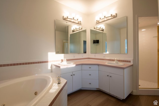 105 S 400 E, Hyde Park, UT 84318 - bathroom with a sink, double vanity, a jetted tub, and wood finished floors