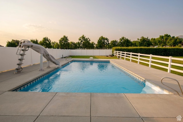 105 S 400 E, Hyde Park, UT 84318 - pool at dusk with fence, a water slide, a fenced in pool, and a patio