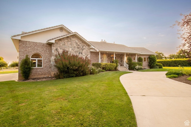 105 S 400 E, Hyde Park, UT 84318 - ranch-style home featuring curved driveway, a front lawn, and a tiled roof