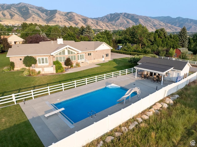 105 S 400 E, Hyde Park, UT 84318 - view of swimming pool with a lawn, a fenced in pool, a patio area, a water slide, and a fenced backyard