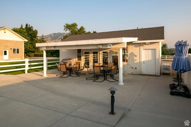 105 S 400 E, Hyde Park, UT 84318 - view of patio featuring french doors, a mountain view, fence, and outdoor dining space