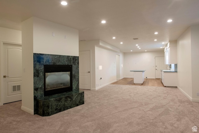 105 S 400 E, Hyde Park, UT 84318 - unfurnished living room with light carpet, visible vents, and recessed lighting