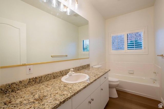 105 S 400 E, Hyde Park, UT 84318 - full bath featuring toilet, a garden tub, vanity, and wood finished floors