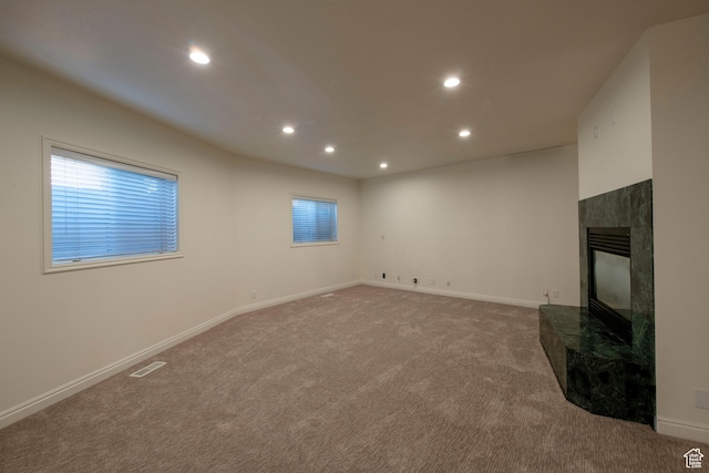 105 S 400 E, Hyde Park, UT 84318 - unfurnished living room featuring baseboards, a tile fireplace, recessed lighting, and carpet floors