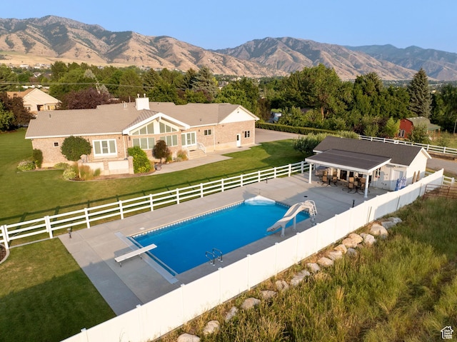 105 S 400 E, Hyde Park, UT 84318 - view of swimming pool featuring a yard, a fenced in pool, a diving board, and a fenced backyard