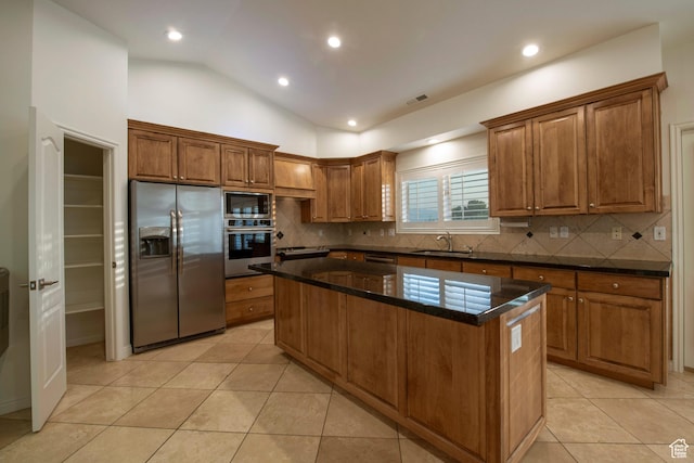 105 S 400 E, Hyde Park, UT 84318 - kitchen with brown cabinets, decorative backsplash, a sink, appliances with stainless steel finishes, and a kitchen island