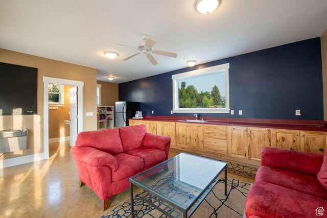 105 S 400 E, Hyde Park, UT 84318 - living area featuring finished concrete floors, baseboards, and a ceiling fan