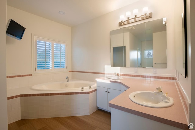 105 S 400 E, Hyde Park, UT 84318 - full bath featuring double vanity, a garden tub, wood finished floors, and a sink