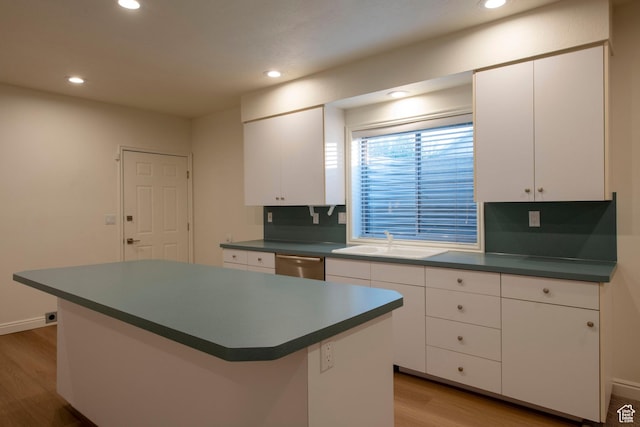 105 S 400 E, Hyde Park, UT 84318 - kitchen featuring stainless steel dishwasher, dark countertops, light wood-style flooring, and a sink
