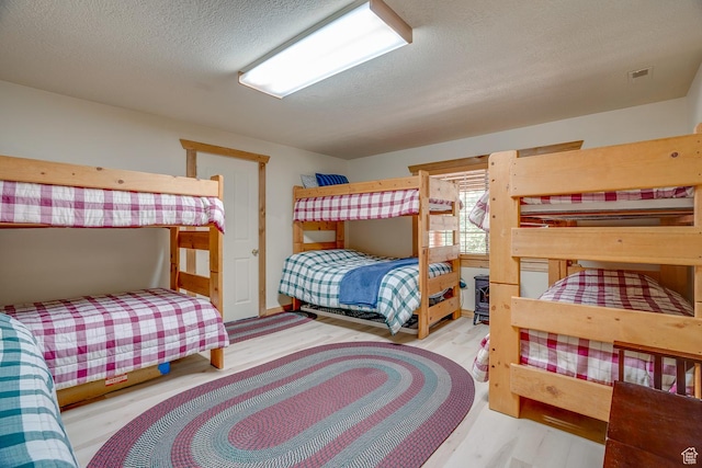4571 Fawn Way, Heber City, UT 84032 - bedroom featuring a textured ceiling and wood finished floors