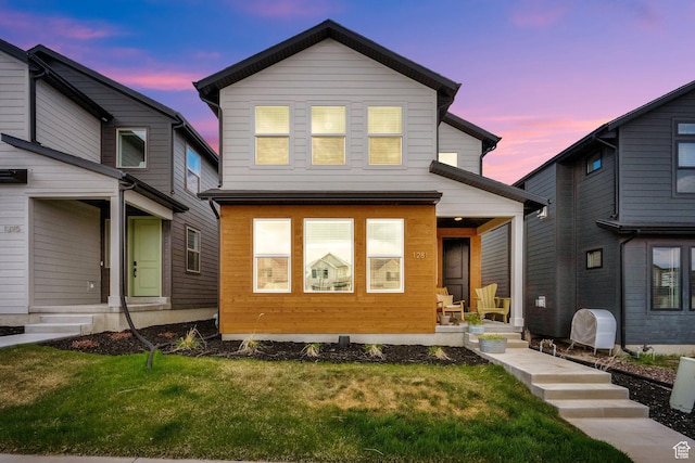 1281 Village Green Trl, Park City, UT 84098 - back of property at dusk with covered porch and a lawn