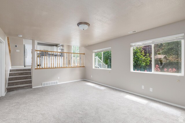 3391 W 1125 N, Layton, UT 84040 - unfurnished room with carpet flooring, a textured ceiling, baseboards, and stairs