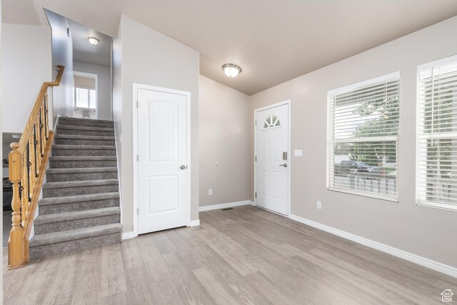 3391 W 1125 N, Layton, UT 84040 - foyer featuring light wood finished floors, baseboards, stairs, and lofted ceiling