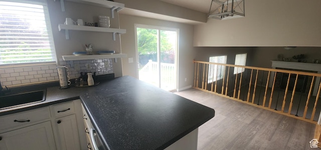 3391 W 1125 N, Layton, UT 84040 - kitchen with open shelves, white cabinetry, light wood-type flooring, dark countertops, and backsplash
