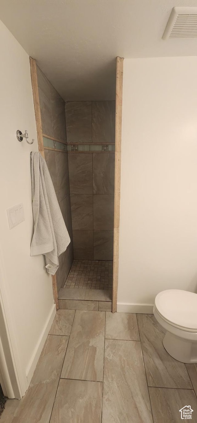 3391 W 1125 N, Layton, UT 84040 - bathroom featuring tiled shower, baseboards, toilet, and marble finish floors