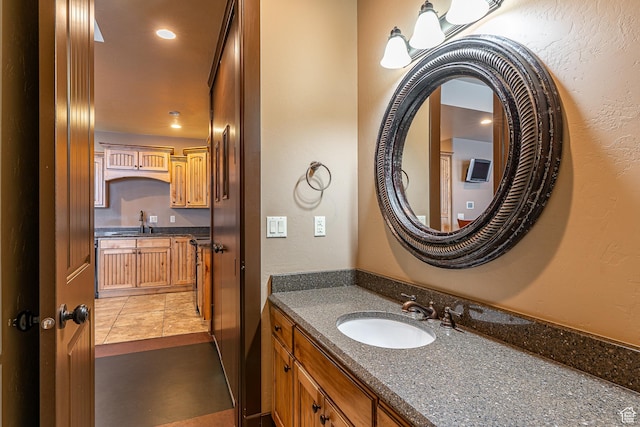 bathroom featuring vanity and a textured wall