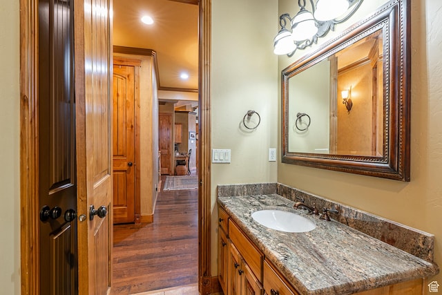 bathroom with vanity, recessed lighting, and wood finished floors