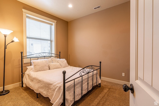 carpeted bedroom with baseboards and visible vents